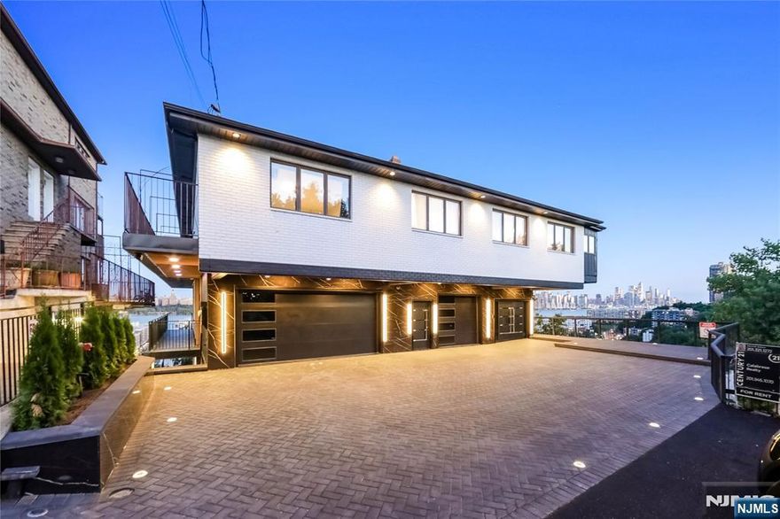 Perched high on a cliff, this exceptional 5-bedroom, 3-bath duplex apartment approximately 4,130 square feet with a 1,890 square foot balcony offers the ultimate blend of luxury, privacy, and breathtaking scenery. Featuring a rare wraparound balcony on each level, you'll enjoy unobstructed, panoramic views of the iconic New York City skylineâ€”day or night, the vista is simply unforgettable. Inside, the spacious open-concept layout is flooded with natural light from floor-to-ceiling windows, seamlessly connecting indoor and outdoor living. Separate entrances to each level from the exterior and an interior spiral staircase. The top level includes large living room with dining area, modern kitchen,, primary suites boast direct balcony access, an en-suite bathroom, 2 additional bedrooms and a full bath. The lower level includes a brand new gourmet kitchen, huge living room/family room, two large bedrooms and a full bath. Each kitchen is equipped with premium appliances and sleek finishes, perfect for both quiet nights in and entertaining guests. Laundry is in unit on each level and also one car attached garage parking and one outdoor parking spot. High ceilings with recessed lighting throughout. Set in an exclusive, quiet location yet just minutes from the city, this apartment is a rare opportunity to live above it allâ€”private, dramatic, and unforgettable.