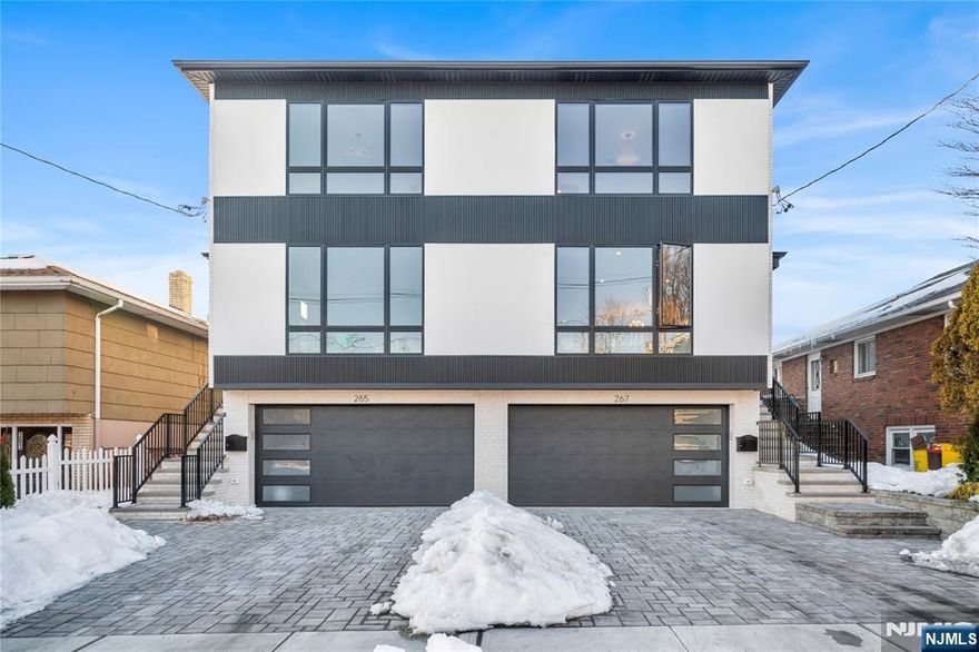 Introducing 267 13th Streetl, a one-of-a-kind, brand new four-story townhome on the border of Palisades Park and Fort Lee. This modern residence offers three levels of living space, plus a rooftop terrace with Meadowlands and sunset views. Main Level features 9' ceilings and open-concept design w a spacious living room w a linear gas fireplace and built-in shelving, dining room, modern kitchen w oversized island, GE Cafe appliances, and under-mount lighting, and family room w sliding doors to private deck. 2nd Floor: Primary bedroom complete w double closets, oversized windows, and spa-like bathroom. Two additional well-sized bedrooms share a hallway bath, offering plenty of space for family or guests. Rooftop Terrace: staircase leads to the rooftop terrace providing a perfect spot for entertaining, enjoying views, or unwinding in privacy. Ground Floor complete w recreation room, office/bdrm, full bath, and side entrance out to the yard.