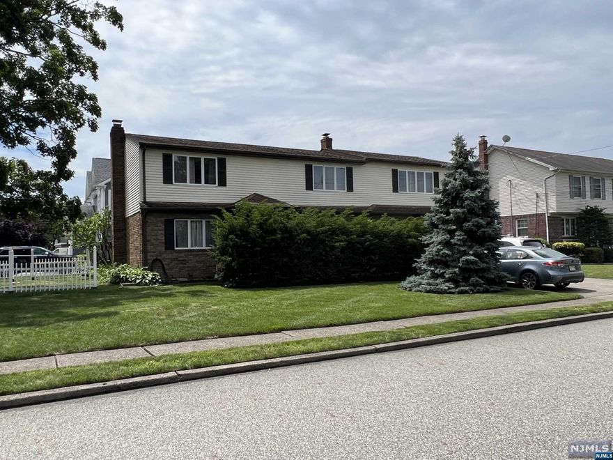 LARGE COLONIAL (2356 SQ FT) , 5 BEDROOMS AND 4 BATHROOMS. GREAT FOR LARGE FAMILY FINISHED WALK OUT BASEMENT HARDWOOD FLOORS BOTH FLOORS, LARGE FAMILY ROOM WITH WOOD BURNING FIREPLACE. TWO ZONE CENTRAL AC AND DESIRABLE BASEBOARD HEAT. THERE IS THE WHOLE HOUSE WATER SOFTENER INSTALLED.CONVENIENT LOCATION CLOSE TO NYC TRANSPORTATION,PARK, SCHOOLS,HOUSES OF WORSHIP