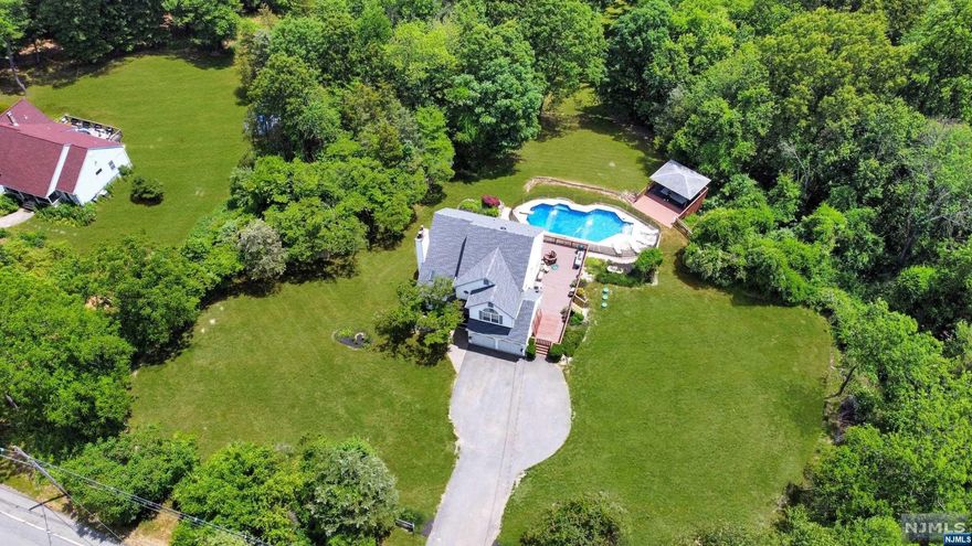 Stunning Colonial Situated on 5.18 Acres of Park Like Land Located in Blairstown. This beautiful home features 3 bedrooms, 2 1/2 bathrooms, an Oversized 2-Car Garage, Family Room with High Ceilings, Skylights & Pellet Stove Perfect for those Cold Winter Nights, Spacious Eat-in Kitchen with Center Island, Granite Countertops, Soft Pull Cabinets & Stainless Steel Appliances w/ Sliding Glass Doors going out to Large Deck Perfect for Entertaining, Laundry Room on the First Floor with plumbing for a sink, Upstairs has 2 spacious bedrooms & Large Primary Bedroom with Cathedral Ceilings, Full Bath Including Jetted Tub & Walk-in Shower + Walk-in Closet, Partially Finished Walk-out Basement going out to Under-the-deck patio with steps going out to the Gazebo & Pool with Jet Features, Take a stroll through the backyard and follow the path to the small stream with a bridge. This property has it all! Some Recent Upgrades Include: Newer Roof (2019), Newer Skylights (2019), Newer Pool Liner