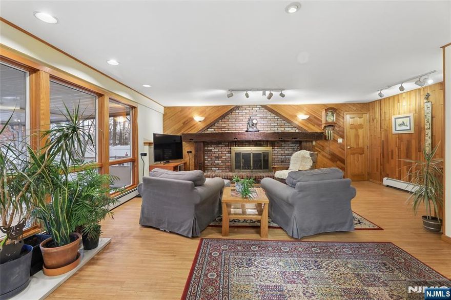 Imagine enjoying your morning coffee in a peaceful screened-in porch or relaxing by the wood-burning fireplace on a chilly evening. Welcome to this inviting home with unique features set on a desirable corner lot property. You will find classic style and everyday convenience in this beautiful 3-bedroom, 1.5-bath home. Located in the heart of Oakland, you'll be just minutes away from schools, shopping centers, parks, houses of worship and NYC transportation.Interior Highlights: Inviting Living Spaces: The spacious living room features vaulted beamed ceilings. Step down to the cozy family room boasting a unique decorative wood and brick accent wall with a wood-burning fireplace and honed mantel perfect for chilly evenings. Open & Airy Layout: Enjoy a seamless flow between the living room, dining area and kitchen, ideal for both daily meals and holiday hosting. Outdoor Living: Relax in your private screened-in porch or head out to the patio " perfect for summer BBQs, outdoor fun or just relaxing. Nestled in a desirable Oakland neighborhood with convenient access to everything you need, this home offers comfort, charm and an unbeatable location. Come and see why this home feels special the moment you walk in.