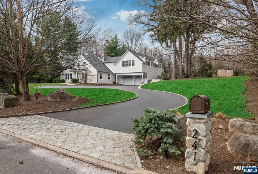 Originally built in 1826 and masterfully expanded and renovated, this exceptional Ramsey estate blends timeless character with sought-after amenities on 1.2 private, resort-like acres. The home showcases restored barn wood flooring, custom millwork and cozy fireplaces, while modern enhancements include a chef's kitchen, radiant heat, smart home technology, a whole-house generator and solar panels. Designed for both elegant living and effortless entertaining, the seamless layout flows from sophisticated interior spaces to an extraordinary outdoor retreat featuring a heated saltwater pool, hot tub, sport court and beautifully landscaped grounds with bluestone walkways, a pergola and mature privacy plantings. The home offers five spacious bedrooms including a luxurious primary suite, multiple living areas, a sun-filled office and a finished lower level complete with a home theater, gym, and sauna -- creating a rare opportunity to own a one-of-a-kind residence that perfectly balances convenience with modern luxury. Ideally located in Ramsey, a highly sought-after Bergen County community known for its charming downtown, top-rated schools, vibrant dining scene and New York City commuter access, this home offers ultimate lifestyle.