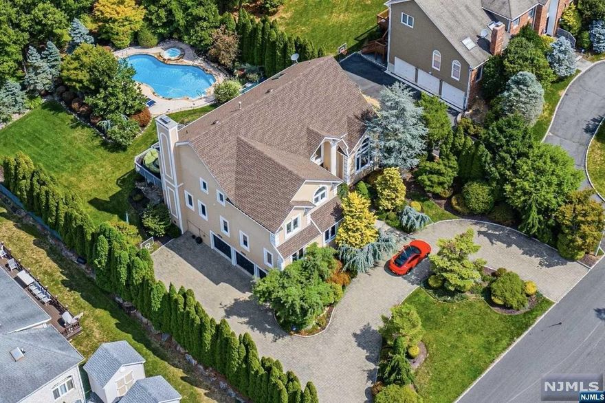 WATCH VIDEO of this beautiful sophisticated modern colonial is located in one of Montville's most desirable area. Attention to detail is obvious the moment you walk through the door. Enter into the grand two-story foyer w soaring ceilings. The modern gourmet kitchen has beautiful custom cabinetry w center island, Sub Zero refrigerator, 6 burner Dacor stove w pot filler & new SS dishwasher & double wall oven. The kitchen opens to a large sun filled family room w a stone gas fireplace, casement windows & beautiful french doors open to large deck, overlooking sprawling yard and pool. Entertain your guests in the great room located on the main level, with a state of the art home theater set up w automated shades for movie & game nights. Main floor features home office or in law suite w full bath. Second floor stunning master BR suite w trey ceiling, HW floors, custom built-in cherry wood closets & large marble en-suite bathroom w steam shower. 3 additional bedrooms & full bath