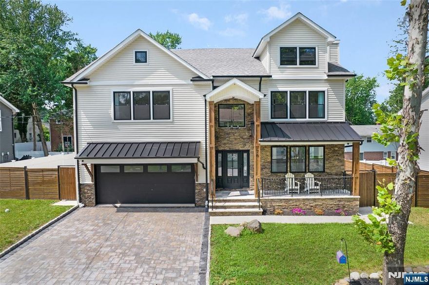 Constructed in 2023, this home opens to a light-filled interior where wide-plank floors, layered textures, and statement lighting bring depth and warmth to every room. The kitchen stands out with white shaker cabinetry, quartz countertops, a waterfall island, pot filler, new appliances, and two distinct sinks: one a deep farmhouse basin, the other a sleek stainless option. The living area features a floor-to-ceiling stone fireplace and oversized windows that frame the space in natural light. The dining room adds architectural interest with bold black paneling, open shelving, and a built-in bar. Upstairs are four spacious bedrooms and three and a half bathrooms, including a serene primary suite with vaulted ceilings and exposed beams. The walk-in closet offers custom storage, while the spa-style bath includes a freestanding tub, marble-clad rainfall shower, dual vanity, and matte black fixtures. A full basement and two-car garage add convenience and flexibility, completing a home where every finish and feature feels intentional. Located right down the street from beautiful Tedesco Park!
