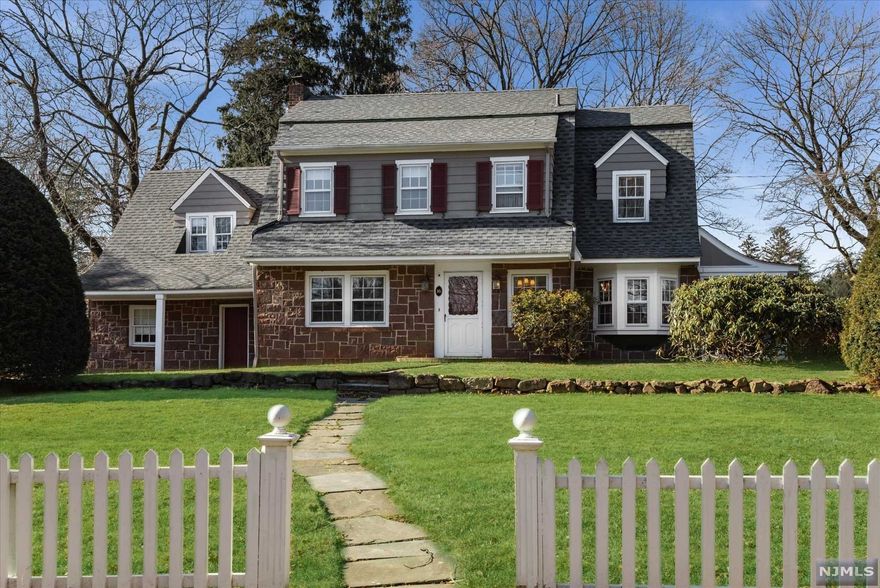 Classic center hall perched behind a white picket fence conjuring images of the American dream. Nestled upon almost 1/2 acre this home has killer curb appeal & offers enormous opportunities for expansion. Presenting gracious center hall, hardwood floors, wood burning fireplace & spacious open rooms, it is centrally located just moments from elementary school, downtown, & NY transportation. Expanded sunlit country kitchen w/turret style breakfast room showcases the back yard while adjacent mudroom leads to one of 2 screened porches & attached 2 car garage. Upstairs awaits the freshly painted primary bedroom offering 2 large closets plus dressing alcove connecting to the main hall bath. 3 additional roomy bedrooms, full walk up attic and lower level with bonus recreation room complete the package. Updates include: Newer roof, 3 year old boiler & hot water heater, plus renovated powder room. Expand or utilize the existing space, make this your Glen Rock dream come true.