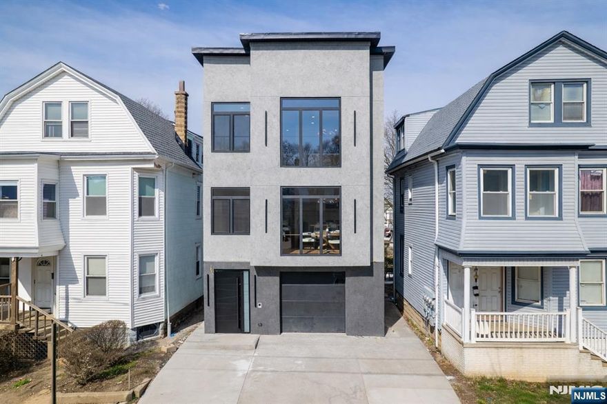 A statement of sophistication and craftsmanship, this custom new-construction two-family residence redefines modern living in Irvington, NJ. Designed with an emphasis on natural light, open flow, and contemporary elegance, every element of this home exudes refinement. From the 9-foot ceilings and gleaming hardwood floors to the European windows and designer tile-work, each detail has been curated for comfort and style. The chef's kitchen showcases quartz countertops, premium stainless-steel appliances, and a stunning center island perfect for entertaining. Step into the primary suite complete with a walk-in closet and spa-inspired bath. The versatile lower level provides ample additional living space, ideally for recreational room, media room, yoga room the options are endless, additional half bath, laundry, and access to an oversized garage. All this at a value that is truly unmatched in today's market. Incredibly low taxes and 5 year benefits apply. Conveniently located close to parks, shops, eateries, NYC commute, & so much MORE!