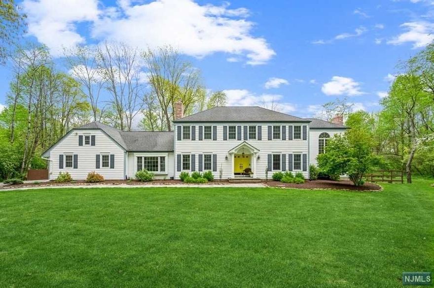 Stunning Colonial home on almost 2 acres of freshly landscaped prop. This home incl a massive deck w/a hot tub overlooking the beautiful backyard, a shaded stone paver patio & walkways. There is also a storage shed & a 20x20 ft outbuilding w/a concrete flr & electric. The interior feat hardwood flr & crown molding, w/the foyer opening to a sun-filled LR. French doors lead to a gorgeous 2-story great rm w/floor-to-ceiling windows, fireplace, built-in bookshelves & an oak spiral staircase to the primary BD. The eat-in kitchen feat granite counters & high-end appl. A stunning sunrm off the kitchen makes a delightful breakfast rm w/vaulted ceiling, skylights & 3 walls of windows. FR boast a raised-hearth brick fireplace, skylights & views of the deck & property. 2nd flr includes the primary BD w/a spacious WIC, a back stairway& private BTH. 3 addtl BDs share a hallway bathroom. The finished LL offers a huge rec-rm, wet bar, an ofc w/built-in shelving,a half BTH & plenty of storage.