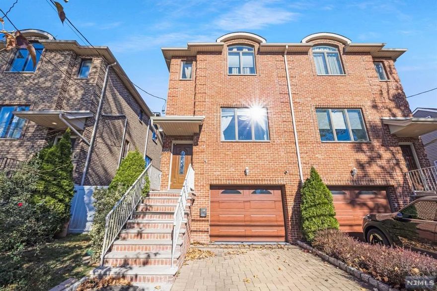 Elegant and spacious townhouse in Cliffside Park with beautiful wainscoting, crown moldings, and premium lighting throughout. The open layout includes a warm fireplace, stylish living and dining spaces, and a chef's kitchen with a breakfast nook leading to a deck. A generous sized family room opens directly to the yard. This home offers 3 bedrooms, including a luxurious master ensuite, an additional full bathroom and 2 half bathrooms. Central vacuum system on every floor! Located on a quiet block east of Palisade Avenue, just moments from the town center and public transportation.