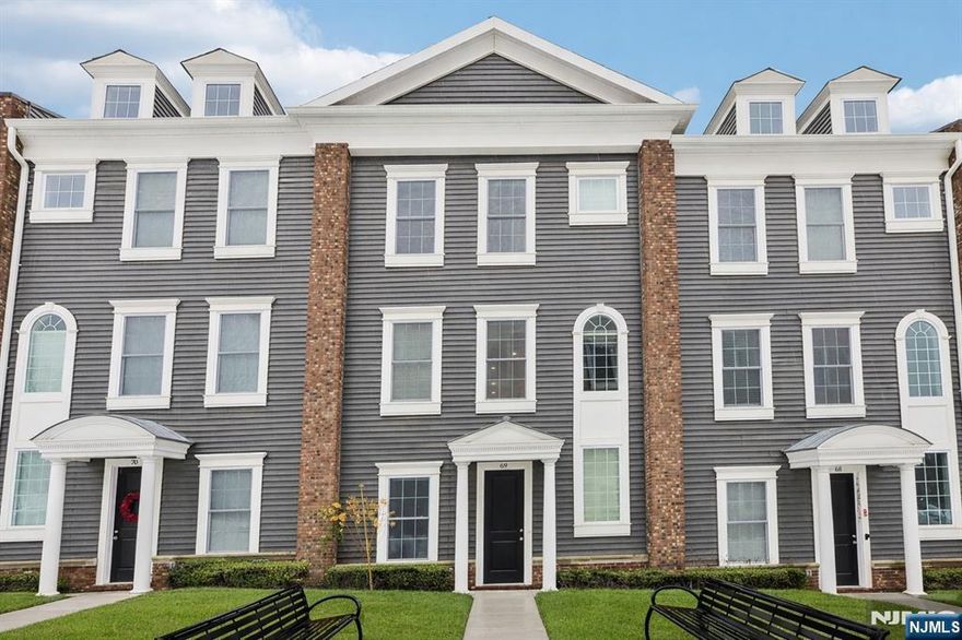 Welcome to this bright and modern Florida Model townhome, offering approximately 2,196 sq ft of living space across three levels. Like-new and filled with natural light, this home features high ceilings and hardwood floors throughout, creating a clean, contemporary feel. The main level boasts an open-concept layout with a white kitchen featuring white cabinetry, a large center island, stainless steel appliances, and quartz countertops, flowing into the living and dining areas that open to an outdoor deck. A powder room completes the level. The third level offers a spacious primary suite with two walk-in closets and a full bath, plus two additional bedrooms and convenient laundry on the same floor. The ground level includes direct exterior access, a two-car garage, a bright office/4th bedroom, and an additional full bath. Located near NYC transportation, shopping, and dining, with snow removal, landscaping, and trash service included, this home offers modern, low-maintenance living. Pets are not permitted; additional administrative fee may apply. Rental requirements: Credit Score 700+, interview, and income = 2.5x monthly rent.