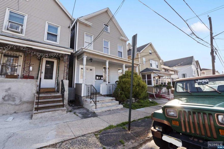 Don't miss out on this unique income producing, legal three-family home. The property consists of two homes on one lot, with the front property offering two 2-bedroom apartments with a finished attic with a full bathroom, and finished basement with a full bathroom, totaling 5 bedrooms and 4 baths. The home on the back of the property is a 2-bedroom single family home consisting of 2 floors. Both properties offer updates all throughout with newer kitchens and some bathrooms This home is perfect for owner occupied or investors! Ideally located within walking steps to NYC transportation, shops, restaurants, schools and parks. Please contact Julian Velasquez at 973-991-5872 for more information.