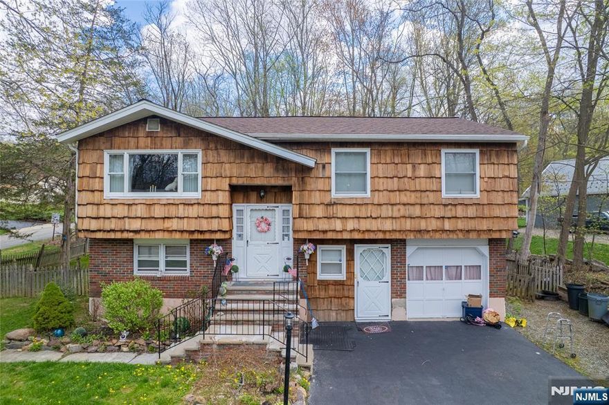 Bi-level single-family home offering 4 bedrooms and 2 full baths with approximately 1,827 sq ft of living space in West Milford. Features an oversized primary bedroom and three additional bedrooms, along with bright living areas on both levels. Situated on a .27-acre lot.