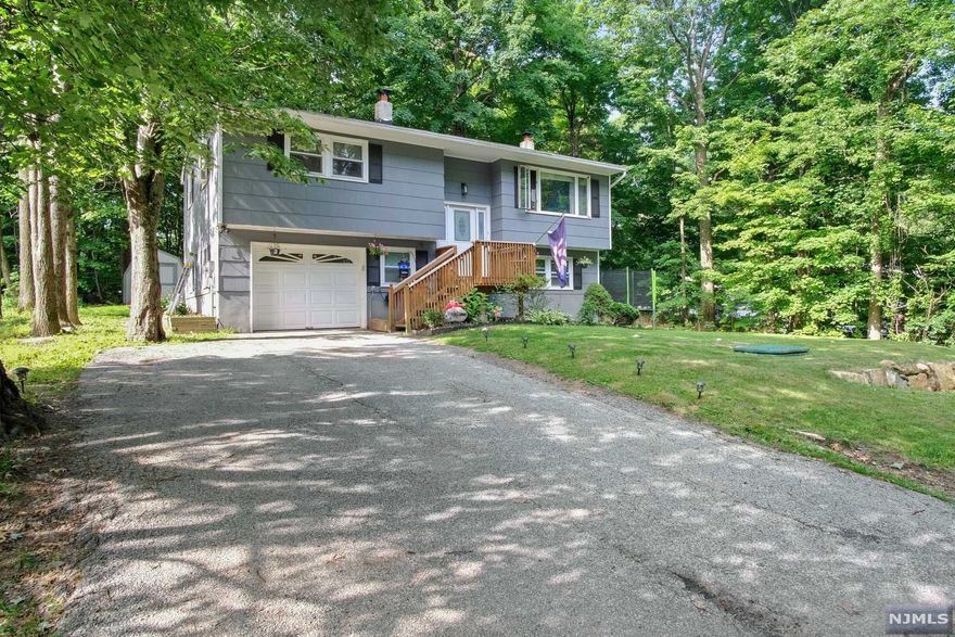 MOVE IN READY! Beautiful Open Concept Bi-Level in the Desirable Barry Lakes Community! This cozy home features 3 full bedrooms & 1 1/2 bathrooms, living room with custom wood beams, sliders go out to expansive maintenance free trex composite deck perfect for entertaining, private wooded backyard w/ new play-set, lower level features large family room with wood burning & pellet stove to keep heating costs low! Enjoy this peaceful neighborhood offering fun activities + all of the year round activities the area has to offer such as hiking, fishing, biking, Historic Warwick + local wineries, Crystal Springs, Great Gorge & Mountain Creek Resorts, And SO Much More! Some upgrades include: Newer Septic (2020), Newer Roof (Jan 2020), Water Conditioning System (2020), Newer Dishwasher (2020), Refinished Harwood Flooring + Tile + Carpeting (2022), & Smart Nest System which is included with the sale. You don't want to miss this stunning home ready for you to move right in!