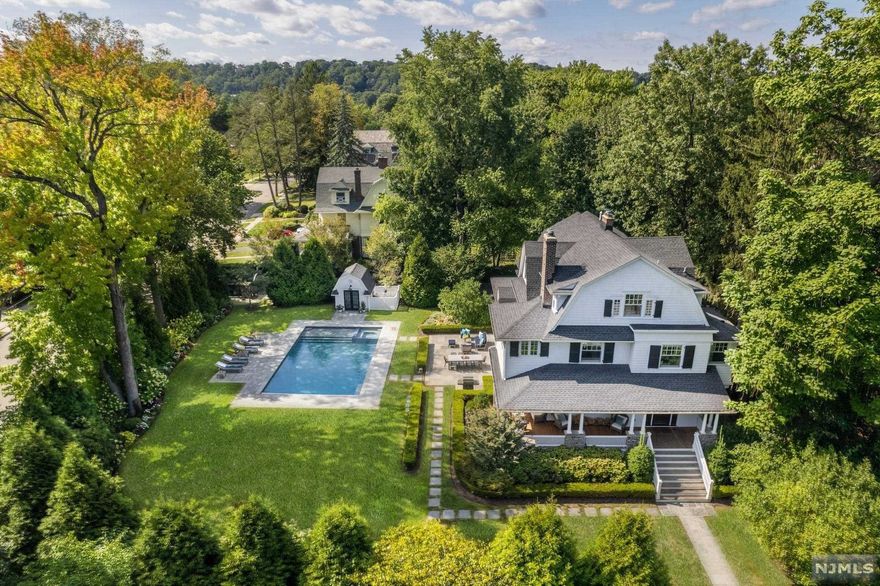 Bring your toothbrush and move right in! This stunning Hamptons-like retreat was masterfully reinvented between 2013 to 2016 w/ every modern amenity. The beautiful fully fenced property features a Gunite heated saltwater pool & spa surrounded by mature trees & plantings for total privacy. Just 2 short blocks from Up Montclair for shopping, dining & NYC commuting. Huge bluestone patio overlooking the manicured grounds & sweeping lawn includes a Sonos sound system & pool house. Step inside to your open flow, chic abode w/ reclaimed hickory floors, a bar w/ Sub Zero wine cooler & 2 wood-burning custom fireplaces w/ gas starters. The gourmet kitchen boasts a Wolf range, new Sub Zero refrigerator & new microwave. Dining rm w/ banquette for 10, mudroom & powder rm complete 1st fl. 2nd fl primary suite of your dreams.2 more large bedrooms, one w/ ensuite bath w/ heated floors. The 3rd floor, w/ 2 additional bedrooms, family rm, laundry rm, and sunny exercise rm is a haven.