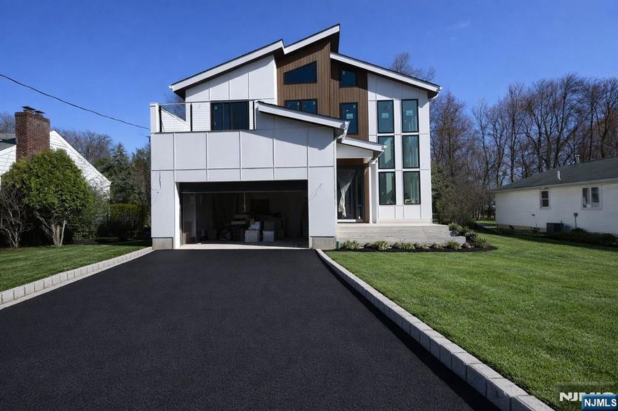 Welcome to 52 Congressional, this stunning new construction home features 6 bedrooms and 5.5 baths, seamlessly combining timeless elegance with contemporary comfort. As you enter, the grand 2-story foyer welcomes you, leading into an open-concept layout that is perfect for both relaxing and entertaining. The formal living rooms create an inviting atmospheres for gatherings, while stylish powder room offer convenience and sophistication. The chef's kitchen is a true masterpiece, showcasing a waterfall-edge quartz island, designer tile backsplash, and custom 46-inch cabinetry. High-end stainless steel appliances. The family room opens up to a spacious patio, providing breathtaking views of the private backyard oasis. Upstairs, you will discover a luxurious primary suite featuring two custom walk-in closets and a spa-inspired bathroom with dual vanities, a deep soaking tub, and a glass-enclosed shower. Step out onto your private balcony a perfect spot to unwind. In addition to the primary suite, there is another en-suite bedroom, two additional bedrooms sharing a well-appointed bathroom, and a thoughtfully designed laundry room equipped with cabinetry and a sink for added convenience. The fully finished walk-out basement include a large recreation room, a stylish bar, a fitness area, a guest suite, and a full bath. home include a 1-car EV-ready garage, a mudroom, an charming concrete patio . 10-year builder's warranty. Picture are From Similar home. All sqft are approximate.