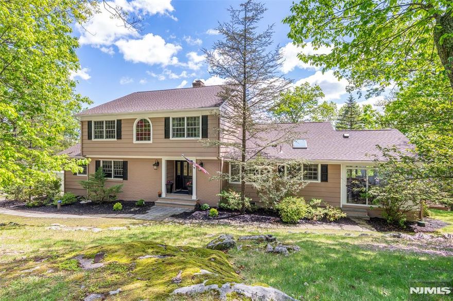 Located in sought-after Kinnelon, Smoke Rise is one of New Jersey's most prestigious gated lake communities. Offering 24/7 security, a private lake, beach, tennis/pickleball courts, equestrian options, and dining at The Smoke Rise Inn, it's more than a neighborhood it's a lifestyle. Residents enjoy scenic trails, a strong sense of community, and year-round activities in a peaceful, natural setting just 30 miles from NYC. Wake up to breathtaking horizon views from this sun-filled home, where picture windows bathe every room in natural light. The updated kitchen flows seamlessly into the spacious LR/DR combo perfect for entertaining. Cozy up by the fireplace, grab a book from the built-ins, or step into the screened porch or out onto the deck to take in the exquisite view. The main level features a serene primary suite with a renovated bath, steam shower & WIC, plus a 2nd BR, full bath, and a bright den/home office. The finished walk-out basement offers a fireplace, wet bar, and powder that can be used as a wonderful recreation space or possible in-law/au-pair suite. Upstairs boasts two oversized bedrooms, both with WICs, and a shared bath with vaulted ceilings, skylight & jetted tub. Experience resort-style living every day in this stunning mountaintop retreat, perfectly perched on a quiet cul-de-sac. Updates include: New roof, new well pump, 2 dishwashers, new induction cooktop, new exterior paint.