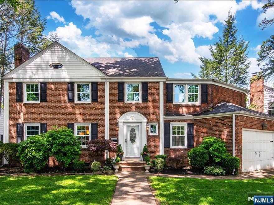 Upper Montclair gem! Fabulous 4 bed, 3.1 bath colonial on gorgeous tree-lined cul-de-sac within walking distance of NYC train station, Iris Gardens, town pool and tennis courts, schools, parks and beloved Applegates -- the best ice cream! Wonderful open flow from spacious sun-drenched living room with wood burning fireplace and shuttered windows, to bright dining room with sliders to oversized back deck and fully fenced yard (swing set included!), perfect for entertaining! Large kitchen with breakfast bar connecting to DR and hallway for circular flow, wood cabinets, granite counters and stainless steel appliances (new DW!). Convenient walk-out to oversized double garage with electric doors. Large, windowed first-floor powder room perfectly located adjacent to front door. Four bedrooms on second floor. Large, light-filled primary suite and adjoining bathroom with stall shower. Additional oversized bedroom with two closets and two more bedrooms with connecting door for secret sleepovers! Bright hall bathroom with tub shower. Fabulous, enormous basement rec room with high ceilings, wet bar with granite counters and new wine fridge, another full bathroom with oversized shower, laundry with new dryer, and utility room. Central air completes the picture for a wonderful summer in your new fabulous Upper Montclair home!