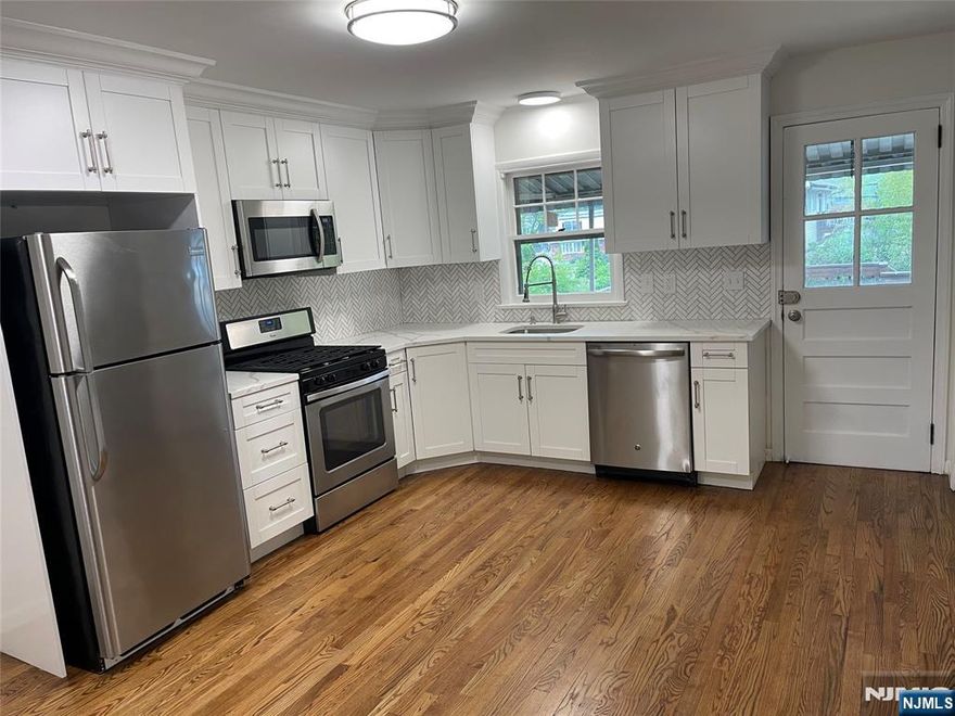 Beautiful updated 1st Floor Apartment. 4 Bedrooms, 1.5 Baths. Kitchen w/Stainless Steel Appliances Quartz Counter Tops. Dining Room, Living Room. Basement has Full bath Washer/Dryer and Entrance to yard. Large Driveway and Plenty of Street Parking. Use of Yard. Close to Train and Center of Town.