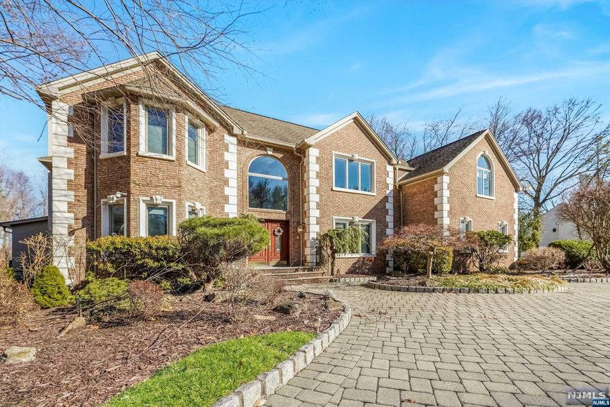 Center hall colonial located in serene cul-de-sac of Water's Edge. Immerse yourself in the stunning views of Lake Tappan from the comfort of your own home. As you step inside, you are greeted by a grand two-story foyer that leads you to the spacious open floor plan kitchen and family room. The attached sun room addition is a highlight of the home, featuring wall-to-wall windows/skylights, creating a bright & airy ambiance. Perfect home office w/ breathtaking view of the lake. The backyard is a true outdoor oasis, w/ inground gunite heated pool, spa, & waterfall, making it the perfect place to relax and soak up the sun. The custom BBQ area, complete with two gas stoves, is perfect for entertaining guests and hosting barbecues. The custom pool house, complete w/ a bath, kitchen & sauna is an added bonus for those who love to entertain. Fully finished basement offering storage , workshop, gym, rec room/wet bar. Blue Ribbon schools and close to NYC transportation & shopping.