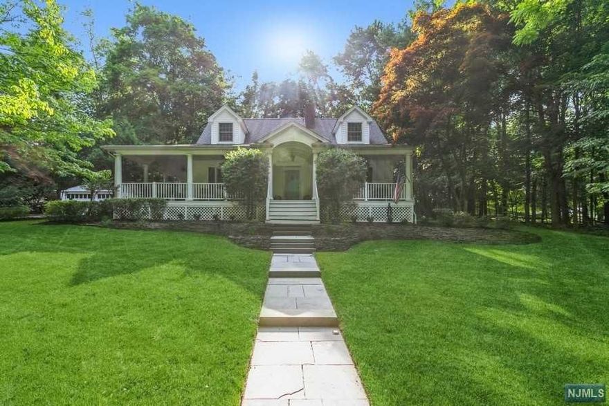 Privately located on a gorgeous .62 acre property on Haworth's sought after west side, this stunning 3 BR, 2 Bath home is surrounded by nature & overlooks wooded town land. In 2010 a masterfully designed wrap around front porch w/ ipe decking was added, offering incredible outdoor living & entertainment space. EF; DR; spacious LR w/fpl and door to private yard; Updated EIK w/custom butcher block countertop; 1st Fl. BR & Full Bath. 2 Large BR; New Bath. The lower level offers a recreation room w/fpl; utility/storage/work area. Many new windows & new c/a & roof (2010); wood floors, irrigation system, 2 car detached garage. Move in & enjoy or expand! Haworth is home to 2 private golf & country clubs, 3 mile reservoir nature trail & top-rated K-8 school & Northern Valley HS. 2 miles to Closter's shopping-restaurant plaza w/Whole Foods, Home Goods, Lululemon & more. 12 miles to GW Bridge. The NY Times recently called Haworth "the quintessential small town & postcard pretty".