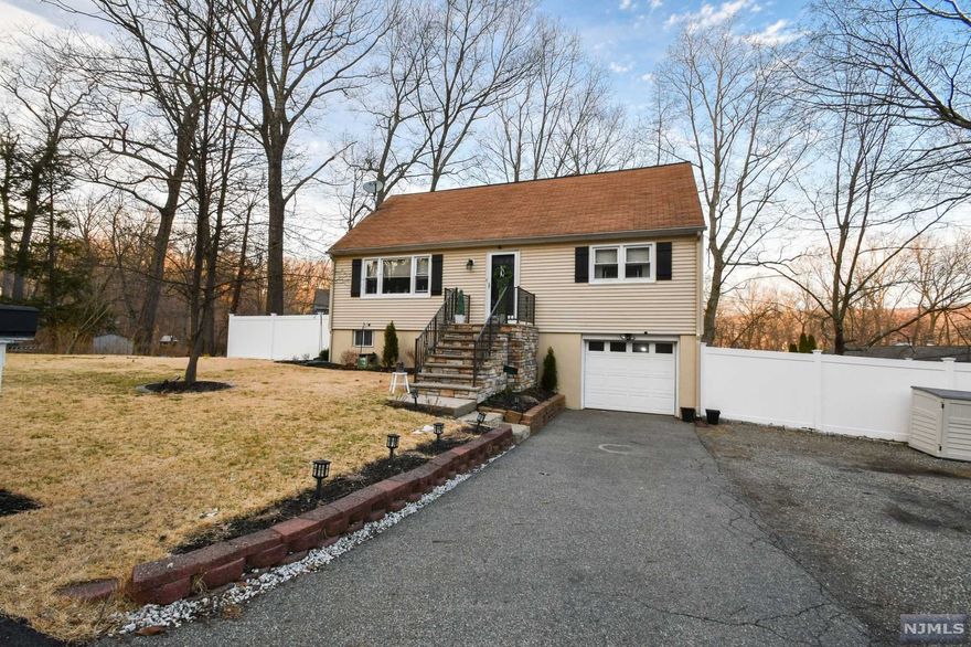 4 bed 2 bath Cape Cod with an attached 1 car garage sits on beautifully maintained corner property. A spacious entryway welcomes you to this cheerful home with gleaming hardwood floors, impeccable molding, designer details, and natural light throughout. Entertain guests in the large and inviting living room which features a picture window. Easily prepare meals in the bright kitchen complete with plenty of cabinetry, sleek granite countertops, a tiled backsplash, and a stainless-steel gas stove. Enjoy meals in the attached dining room. Two versatile bedrooms on the main floor are opposite a full bath. Upstairs the oversized master bedroom boasts a new walk-in closet. A 4th sunny bedroom is across the hall. A newly updated full bath is at the top of the stairs. The partially finished lower level has a recreation room and a bar. Utility space and a newly added laundry area are also on the bottom floor. Unwind on the deck, paver patio, or lawn in the fully fenced yard.