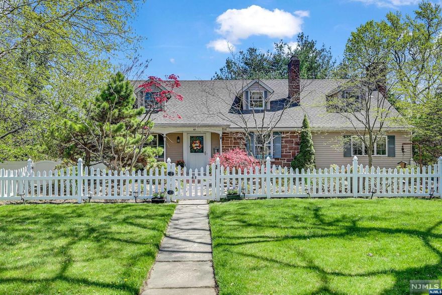 Charm abounds in this classic storybook home with white picket fence and sandstone front. The home is nestled on a quiet street in a top neighborhood in Park Ridge. The open front porch and foyer welcome you into the beamed Living Room with fireplace. The heart of the home is the massive Country Kitchen and Family Room with beamed ceiling and brick fireplace which opens to formal oversized Dining Room and three-season room with woodstove - ideal for family gatherings. The home offers a first floor Bedroom and Bath, plus three additional bedrooms on the second floor. The basement has a finished Rec Room, laundry and full bath with lots of storage. BONUS - separate "carriage house" (formerly garage) with 2 finished rooms and full bath - perfect for home office, artist studio, or guest suite--it also has a full basement workshop. All set on private fenced property-Don't miss this unique home!