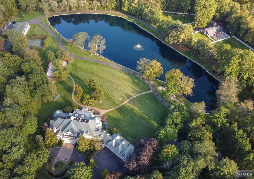 Welcome to Mill Pond! Privacy abounds in this one of kind 14 acre setting. Stunning private park-like property surrounds the 10,000+sf French Manor 2acre aerated pond with walking path, 9 stall horse barn w/ 2 turnout areas for the equestrian lovers, regulation lit tennis court, gunite pool, car collectors garage,5BR/3 bath guest house. Luxurious classic interior of home designed for entertaining includes 6BR,10full 3half baths, elevator to all levels, gorgeous views of the pond from all rooms, and additional 5 car attached heated garage. All within minutes of NYC! A truly unique setting not to be duplicated in Bergen County!!