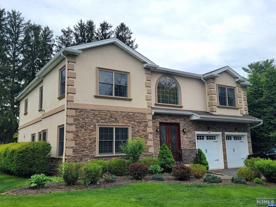 2014 Built 4000 sqft (+ 1800 sqft finished basement) Contemporary Center Hall Colonial with 5 BRs and 5 Full Baths. Entering through the Mahogany triple pane beveled glass front door, you will be falling in love with the 2 story entry, 9ft high ceilings, Cherry wood floors, crown molding, chair rail, recessed lighting, granite countertop, marble/granite bathrooms...etc. Large MBR suite features tray ceiling, 2 walk-in-closets and a luxurious bath with jetted Kohler tub, double sinks, stand shower. Huge open basement has wet bar, full bath, home theater, 8.5 ft high ceiling, which are great for entertaining. Each floor has its own separate heating/AC zone. House also has underground sprinkler and Central Vacuum. Property tax $14,645. See attached document for more features.