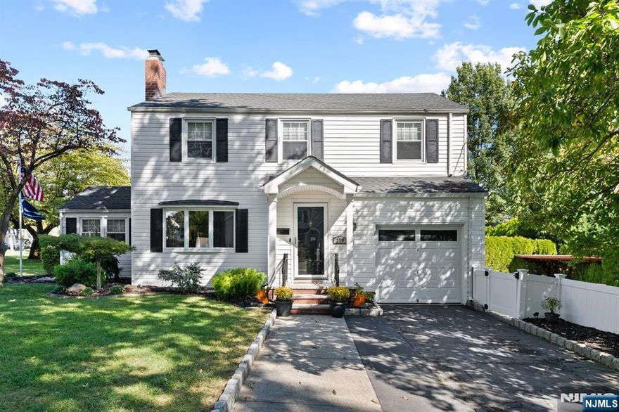 Welcome to 276 Greenway Terrace, a classic River Edge colonial that blends timeless curb appeal with thoughtful updates and a backyard built for fun. The main level opens with a sunny living room anchored by a wood burning fireplace and a bay window, creating a warm gathering space that flows to a formal dining room and a comfortable family room. The renovated kitchen features rich cabinetry, stone counters, stainless appliances, a tile backsplash, and a glass door to the deck for easy outdoor dining. A stylish half bath completes the first floor. Upstairs offers four true bedrooms, including a larger primary, along with an updated full bath with modern tile and niche detail. The lower level provides clean storage, laundry, and flexible space for a gym, playroom, or hobbies. The backyard is the showstopper. A rare in ground pool in River Edge is framed by a patio for lounge chairs and dining, green space for play, and privacy plantings that make every summer day feel like vacation at home. An attached garage and a wide driveway add everyday convenience. Located on a quiet neighborhood street close to parks, schools, shops, and NYC transportation, this home delivers comfort, function, and outdoor living in one inviting package. Move in ready and easy to love, 276 Greenway Terrace is the River Edge lifestyle many buyers are searching for.