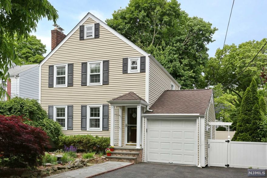 You will fall in love with this sweet charming 2 bedroom colonial in the sought after village of Ridgewood. Charm throughout starting with the living room with wood-burning fireplace, formal dining room, and freshly painted MEIK with oak cabinets and Corian countertops. Off the dining room is a wonderful sunroom perfect for having your morning coffee or a cold drink in the evening. Off the sunroom is a composite deck overlooking the lovely landscaped yard. The 2nd floor boasts a large primary bedroom, a full renovated bathroom and 2nd bedroom. The basement is finished with a laundry area and powder room. It could be a great playroom, office, or work out area. Some special features include central air, hardwood floors, new boiler, new h/w heater, new chimney liner. Located in the desirable Somerville school district, steps to the Duck Pond, and Ridgewood's fabulous downtown with its shopping, restaurants and NYC transportation nearby! You will love living here!