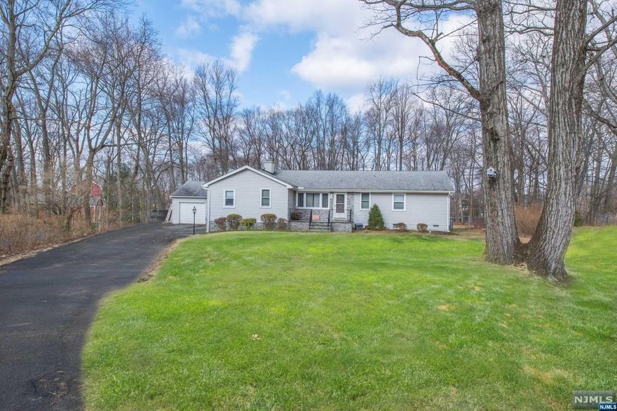 Rare find! Quiet cul-de-sac, beautiful curb appeal, large flat lot and easy first floor living. Enter into a beautiful living room with floor to ceiling stacked stone fire place and large picture window. The fully renovated kitchen is conveniently located with easy access to the family room, dining room and game room. Kitchen features a center island with seating, granite counters, custom cabinets and soft close drawers. 3 bedrooms with hardwood floors under the carpets are conveniently located at one end of the home. The game room is perfect for hosting a party or to enjoy an after work cocktail at the custom bar. Fully fenced in backyard gives seclusion and privacy while entertaining on the large trek deck with a hot tub and canopy to use year round. Close to schools, Lake Valhalla, shopping, great restaurants and NYC. This is one home you won't want to miss! Home is located in Montville with a Boonton mailing address.