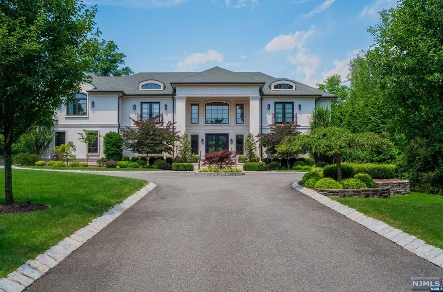 Set on 1.82 lush acres, one of the largest and most private estates in Short Hills, this residence embodies modern elegance and sophistication. A long drive reveals bespoke luxury. Inside, a curved staircase and custom chandelier set the tone. The great room features double-height ceilings and stunning views. The gourmet kitchen boasts state-of-the-art appliances, sleek cabinetry, two islands, and a walk-in pantry. The primary suite on the second level offers a balcony, radiant heated floors, a gas fireplace, and boutique-style closets. The expansive lower level includes recreation areas, an exercise room, a bedroom suite, several storage rooms, and a bonus space perfect for a theater or golf simulator. Outside, enjoy a pickleball court, resort-style pool, fire pit, covered patio with retractable screens, a changing room/full bath, a fully equipped outdoor kitchen, and manicured lawns. This home reflects meticulous attention to detail, offering unparalleled luxury and comfort.