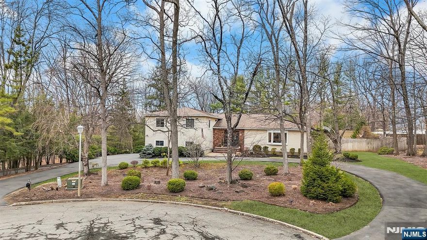 Set on a serene cul-de-sac in Montville Township, this exceptional custom home sits on a beautifully manicured lot. With nearly 3,400 SF of living space, it features 4 spacious bedrooms, including a lavish primary suite with a custom walk-in closet and spa-like marble ensuite. Two additional full baths and a powder room ensure comfort. Designed for elegance and functionality, the home boasts a formal living room with bar, a sophisticated dining room, and a cozy family room with a wood-burning fireplace and French doors to a large paver patio. The gourmet eat-in kitchen offers premium stainless appliances, ample cabinetry, and expansive prep space. Highlights include a basketball court, finished basement, newer circular driveway, Andersen windows, new luxury vinyl plank flooring, generator hook-up, and multi-zone HVAC. With a built-in natural gas grill, Nest thermostat, and lush sprinkler-fed landscaping, 18 Salter Drive offers an unparalleled lifestyle of comfort and sophistication.