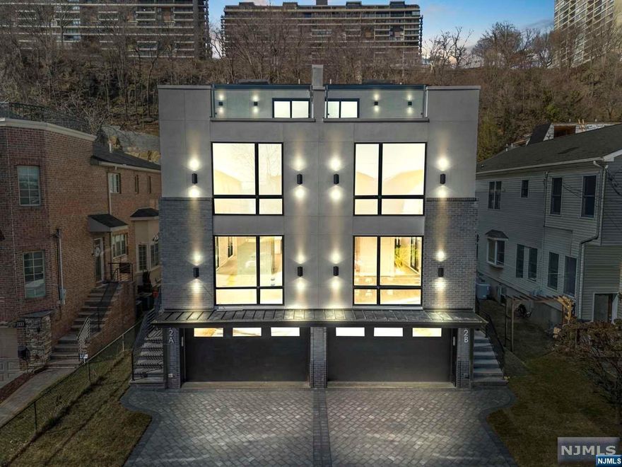 Tucked away high up in North Edgewater sits Myrtle Ave, Edgewater's best-kept secret.This cul-de-sac street is wide, flat and offers a scenic view of the Hudson River and Manhattan.This 4-level modern dream home is offering is built by a top builder.This is a 2Fam side-by-side duplex.Each unit features 3beds, 3full baths, 2half baths with a 2-car garage with a grand terrace.The 1st level offers a 2-car garage, powder room, expansive recreation room and an ELEVATOR that services all 4 floors.The 2nd level is met with an entry foyer, powder room, living room, dining room and a custom stylish kitchen with luxury Sub-Zero and Wolf appliances.The 3rd level offers a posh master bedroom suite complete with 3 closets and a luxurious master bath with double vanity, shower and free-standing tub.Also, the 2nd and 3rd bedroom with a full bath as well as a laundry room.The 4th floor boasts a spacious recreation area with wet bar, powder room and door leading out to the private rooftop terrace