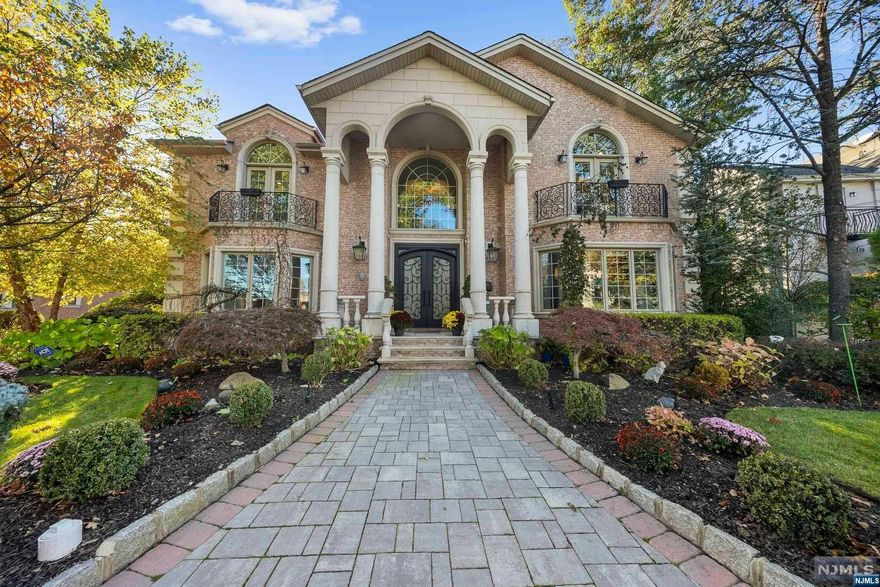 This luxurious property, located in Ft Lee's prestigious Bluff section just minutes from NYC, exudes elegance and sophistication. Meticulous craftsmanship, soaring ceilings, radiant heated flooring, and custom millwork make this a dream home. The gourmet chef's kitchen features a Sub-Zero refrigerator, a 48" Wolf 6-burner range with grill and double oven, a built-in Dacor microwave, Bosch dishwasher, and exquisite imported marble countertops. Butler's pantry w/wet bar and wine fridge is perfect for entertaining. Upstairs, the primary BR suite is a haven, complete with a fplc, spa-like bath, and 2 walk-in closets. Two add'l BRs have en suite baths; 4th BR has a separate bath. Laundry conveniently located on this level. Walk-out lower level boasts 9'ceilings, rec area, gym, 5th BR w/full bath, sauna, wine cellar and storage. Backyard boasts built-in grill and paver patio. Security and camera system. This home is truly exceptional for the discerning buyer. Must see video!