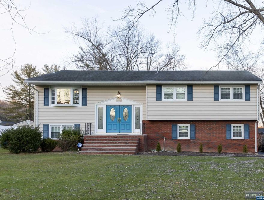 Unique Bi-level with double front doors for a Grand entrance. Unique two side staircases leading up to the first level, and wide center staircase leading down to ground level. Elegant 4 bedroom, 2.5 bath home with large level lot on cul-de-sac in a beautiful neighborhood. Walk into a beautiful foyer, up to the first floor which offers an eat-in kitchen with cherry cabinets and bay window, formal dining room and large living room. On this floor there is also the main bath, primary bedroom with ensuite full bath, and 2 additional bedrooms. Hardwood floors throughout. Lower level has large family room with ceramic tile, big 4th bedroom or office, half bath and laundry room. There is a sliding patio door for walkout to large level backyard. Home has Central Air, newer water heater 2008, furnace 2014, newer windows, siding, and roof. This is a beautiful home in a wonderful location.