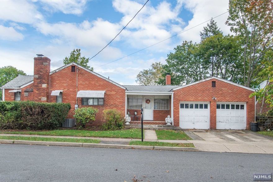 Brick Ranch on corner lot in need of TLC features 2 fireplaces full basement and 2 car garage
