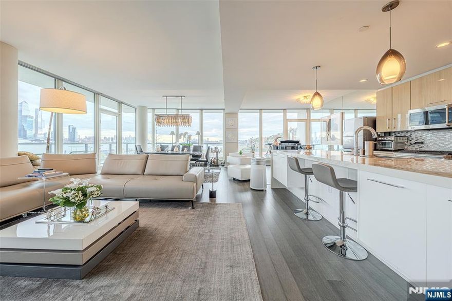 BREATHTAKING VIEWS! THIS VIBRANT SOUTHEAST CORNER UNIT PROVIDES SWEEPING PANORAMIC VIEWS OF HUDSON RIVER AND MANHATTAN SKYLINE. ABUNDANT NATURAL LIGHT THROUGH FLOOR TO CEILING WINDOWS. SPACIOUS SLEEK OPEN CONCEPT LAYOUT WITH WRAP AROUND LARGE BALCONY. CHEF-DESIGNED KITCHEN, MASTER SUIT WITH SPA-LIKE BATHROOM, FIRE PLACE, 2 ENTRANCE DOORS, AUTO WINDOW SHADES, AMPLE STORAGES, 2 GARAGE PARKING INCLUDED. WORLD CLASS AMENITIES INCLUDE 24 HOURS CONCIERGE SERVICE, HEALTH CLUB, MOVIE THEATER, SKY LOUNGE, SERENE POOL WITH FIRE PIT, SAUNA, KID'S PLAY ROOM. COMMUTERS DREAM, NY FERRY, BUS, LIGHT RAIL ONLY STEPS AWAY.