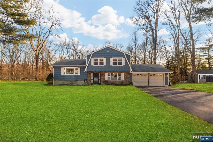 Discover this inviting split level in the desirable Eyland Woods neighborhood. Featuring 4 bedrooms and 2.5 bathrooms, including a full master suite, this property provides 1,912 sqft of living space with hardwood floors.The country style eat-in kitchen is ready for your personal design, and the large deck offers a peaceful spot to relax or entertain. With three bedrooms upstairs and one on the ground floor, the layout adapts easily to your needs.Enjoy the den with a cozy fireplace and reading nook, and take advantage of the two car oversized garage. Set on nearly an acre of private wooded land, this property combines comfort and convenience.Close to schools, parks, and shopping, it's ready for your personal touch. Schedule your showing today to experience all it has to offer!