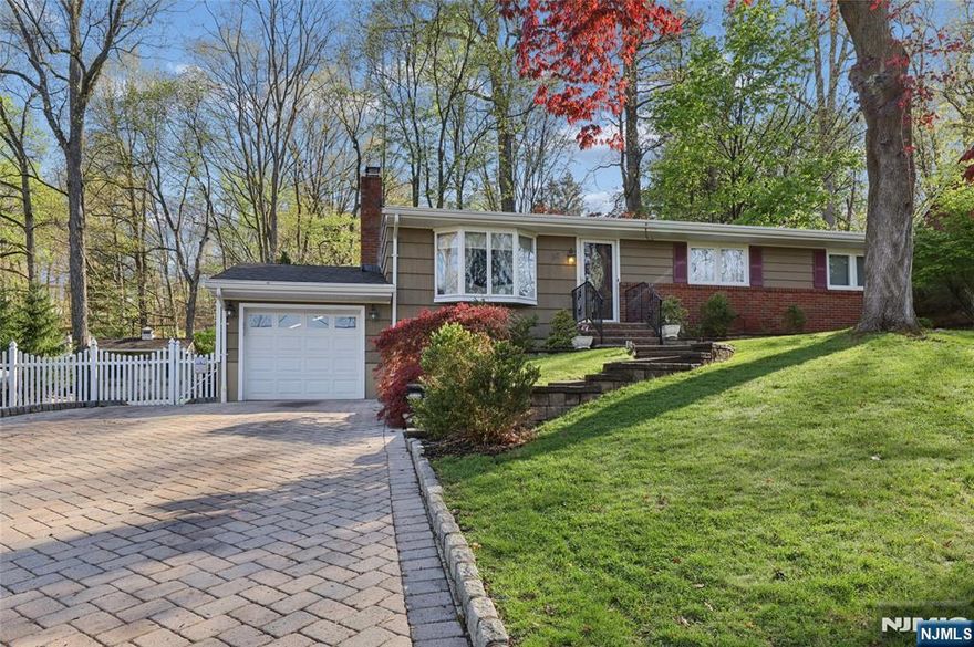Welcome to this beautifully maintained 3-bedroom, 2.5 bathroom ranch with finished basement and garage. Features include updated eat-in kitchen with granite counter tops, breakfast bar, living room with cozy wood burning fireplace, dining room with sliders leading to private backyard oasis, heated hot tub, 2 store deck, fenced yard perfect for entreating. The finished lower level offers rec room, den, office, full bath, laundry room, summer kitchen and utility. Located with top rated schools, minutes away from restaurants, shopping and NYC transport, convenient access to highways. Must see!
