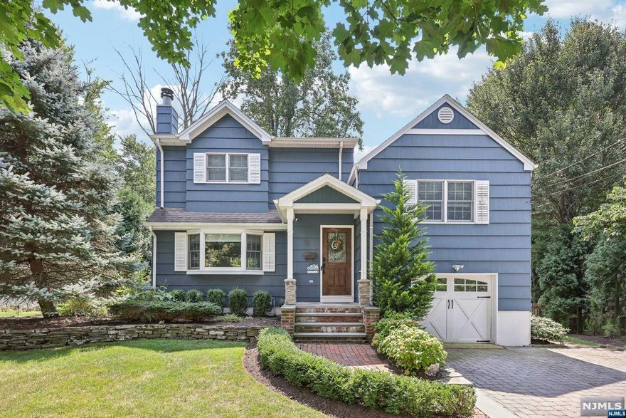 Welcome to 48 Oak Drive, a beautifully updated home in the heart of Roseland. This residence offers a seamless blend of modern design and classic charm. As you enter, you are greeted by natural hardwood oak floors and an open-concept layout, ideal for entertaining. The gourmet eat-in kitchen features Viking appliances, quartz countertops, a marble backsplash, and elegant white shaker cabinets. The adjacent living room is highlighted by a cozy gas fireplace, custom built-in bookshelves, and cabinetry, all enhanced by crown molding and wainscoting throughout. The primary suite features vaulted ceilings, hardwood floors, a walk-in closet, and an en-suite bath complete with a walk-in shower, skylight, and freestanding tub. The lower level offers a half bath with direct access to the private backyard. The fully finished basement provides additional space for living, storage, or entertainment. Don't miss out on this exceptional property!