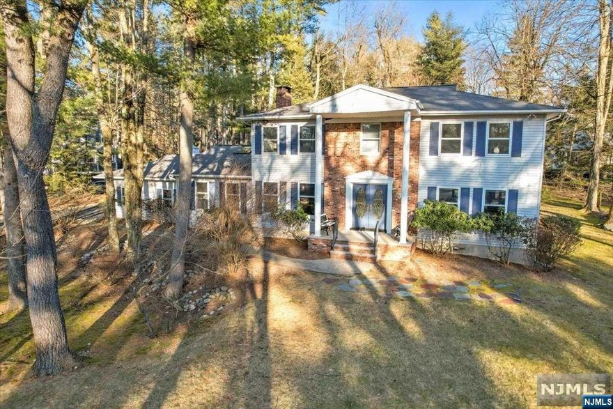 Situated on one of the most desirable streets in town, you can feel the potential of this stately 4-BR 2.5 bath Colonial! Off the entryway there is a generous LR, this flows into a tasteful DR. The extremely large kitchen will be the focal point of the home featuring a 2-sided fireplace opening into a GR w/ lofted ceilings. You can easily picture friends & family gathering in this cozy yet spacious area. An updated half bath & ample mudroom completes this floor. Upstairs there is a large primary BR suite that provides plenty of space to create the primary domain. The 3 additional BRs are all generous in size & there is an updated hall bath w/ double sinks. On the lower level the full high celling basement offers tons of space to make your own. Set on a large private lot in a picturesque neighborhood this house offers incredible value for a savvy home buyer. WANT MORE INFO? CONTACT LISTING AGENT NICOLE MINETTI @ 201-388-0077 or nicole@minettidennisgroup.com