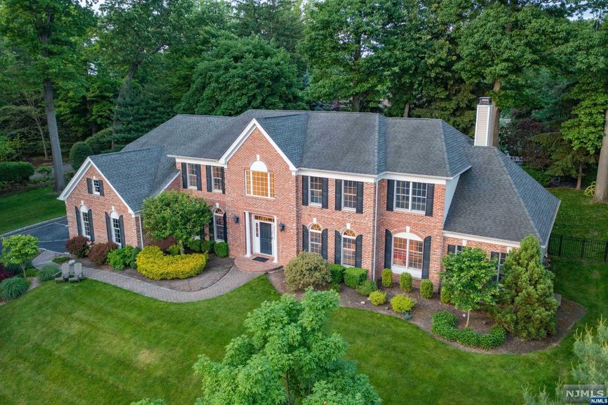 Exquisite 6 bedrooms brick manor in highly sought-after Mulholland Estates showcases modern elegance & comfort. This recently renovated home exudes sophistication with its stunning finishes & attention to detail. Nestled at the end of a double cul-de-sac, privacy & tranquility abound. The main lvl features a dream kitchen w/quartz waterfall island, counters & backsplash, high-end stainless steel applncs, large LR&DR w/custom mill work, great room w/stone FP. Office/playroom, large guest ste w/sitting rm & full bath provide privacy for guests. The oversized primary suite is a retreat with a spa-like BTH, 2 WICs & sep office/sitting rm. 3 spacious BR's, one ensuite, 2 Jack N Jill. Additional highlights include a finished basement, with a spacious wet bar, rec area, bedroom & full bath. Generator, 3 Car garage. Sprawling private yard with deck & lush landscape. With its desirable location, this home presents a rare opportunity for sophisticated living in a premier neighborhood.