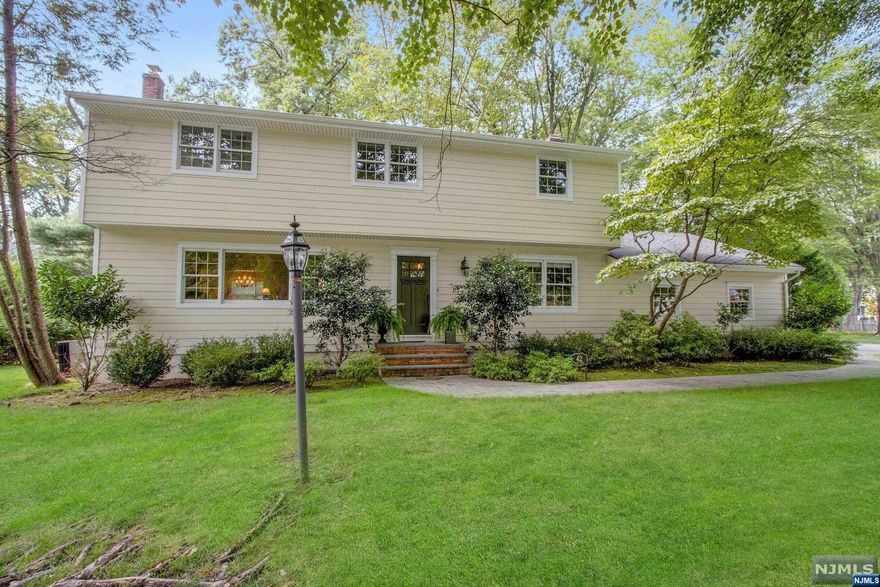 Call The Paula Clark Group for more info: 201-280-0056 Immaculate Center Hall Colonial with beautiful curb appeal and gleaming hardwood floors in Harrington Park. Hardy Plank siding, newer roof, and utilities.Large and bright formal living room, open to a spacious dining room.Updated eat-in kitchen featuring wood cabinets, granite countertops and stainless steel appliances. Large family room including a brick fireplace and large window for an abundance of natural light. A half bath completes this first level. The second level offers a luxurious primary suite with a modern full bath. Three beautiful large bedrooms and an updated full bath completes the second level. Lush, professionally landscaped property offers a lovely deck and beautiful paver patio--great for entertaining! Oversized 2-car garage. Great location, one of Harrington Park's prime, and desirable locations. Close to schools and parks! This home is move-in ready!