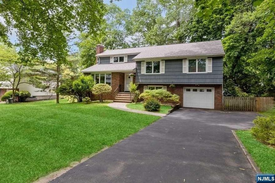 A spacious and beautifully maintained 4 BR, 2.5 Bath home on a quiet tree-lined street in sought-after Demarest! Entry foyer w/closet; sun-filled living rm w/stone fireplace; dining rm w/bay window; updated eat-in-kitchen w/granite counters, ss appliances & breakfast nook w/door to private fenced yard w/patio; family rm; .5 bath; laundry rm; Primary BR w/2 closets & a newer full bath plus 3 additional bedrooms & newer full bath. The finished basement offers a recreation rm, office/gym & sound-proof music rm. Special features of this energy efficient home include a brick & cedar shingle exterior, 2-year roof, 7-yr. central air, 2-zone hot water heat, newer beautiful windows, great closets & storage space, wood floors, inground sprinklers, shed, attached 1-car garage & more. Short walk to Demarest's top-rated k-8 schools, Northern Valley High School, municipal library, Nature Center & charming downtown. Short drive to world class shopping/restaurants & 11 miles to the GW Bridge.