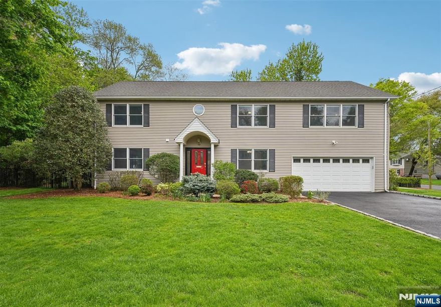 Immaculate Center Hall Colonial on a double cul-de-sac, beautifully rebuilt in 2004, offering exceptional privacy, modern comfort, and a tranquil outdoor setting. This meticulously maintained 4/5-bedroom, 3.5-bath home features approximately 3,300 sqft. of bright, open living space with seamless flow between the eat-in kitchen, living room, dining room, and four-season sunroom, all opening directly to the backyard oasis. A private den/office, mudroom, and powder room complete the first level. The expansive upper-level family room offers flexible space for a gym, media room, playroom, or 5th bedroom. Two en-suite baths feature radiant heated floors, while oversized windows throughout fill the home with natural light and serene, nature-filled views. Enjoy a heated saltwater gunite pool and spa, beautifully landscaped gardens, and direct access to a 6-mile walking and biking trail. Additional highlights include smart home technology, oversized heated 2-car garage, new 4-car driveway, walk-up full floor attic storage, large 2nd level laundry, two-zone central air, three-zone heat, six-zone sprinklers, and numerous recent upgrades, including powder room (2026), driveway and sidewalks (2025), hot water heater (2024), and AC systems (2021). A rare opportunity offering a lifestyle combining privacy, recreation, and move-in ready living!