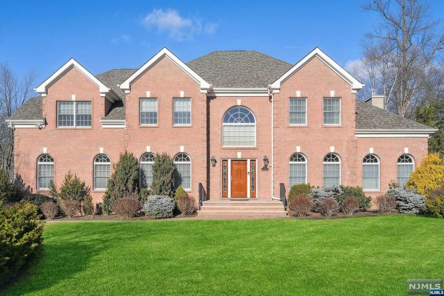 SPECTACULAR BRICKFRONT COLONIAL ON LOVELY CUL-DE-SAC ST. MOVE-IN READY! IMPRESSIVE CURB APPEAL - dramatic arched windows & manicured grounds. TWO-STORY FOYER opens to beautifully appointed home boasting today's color palette, deep crown moldings, wainscoting, volume/tray ceilings, 9 FT CEILINGS ON 1ST & 2ND, custom plantation shutters & rich wood flrs. Chef's EIK w/Thermador, Sub-Zero, Wolf & Viking appls, center island w/brkfst bar & sep eating area w/sliders to Timber Tech deck, FLOWS EFFORTLESSLY INTO STUNNING FRW/GAS FPL. French doors from LR open to den which would be great WFH space or guest BR. Mudroom w/access to OVERSIZED, HIGH CEILING 2-CAR GAR W/EV CHARGER. 2nd flr boasts sumptuous Primary BR w/tray ceiling, sitting area, large WIC & luxurious ensuite bth. CONVENIENT BR-LEVEL LAUNDRY! EXPANSIVE, HIGH CEILING BSMNT W/SPLIT HEAT/AC SYSTEM & ROUGH PLUMBING FOR BTH. GENERAC WHOLE HOUSE GENERATOR. ALL THIS IN HIGHLY SOUGHT AFTER LIVINGSTON KNOWN FOR ITS STELLAR SCHOOLS