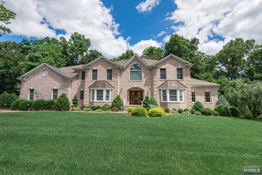 Stunning center hall colonial with Bridal staircase and motorized chandelier. This home features 5,000 sq. ft. including 5 bedrooms and 5 1/2 baths in a dynamic combination of soaring ceilings and traditional formal spaces. The gourmet kitchen is complete with center island, bright breakfast area, and back staircase to the 2nd floor. The adjacent great room is enormous with gas fireplace and wet bar along with the formal dining room and living room. First floor is complete with large bedroom ensuite and full, front to back office or den, with panoramic views of the neighborhood. Four more bedrooms upstairs with formal master bedroom and bath, 2 more bedrooms with main bath, and another large bedroom ensuite. Also included are 9 zone hot water heat, 4 A/C units, central vac, whole house water filter, generator, paver driveway, Koi Pond, 3 car attached garage, and fabulous landscaping.