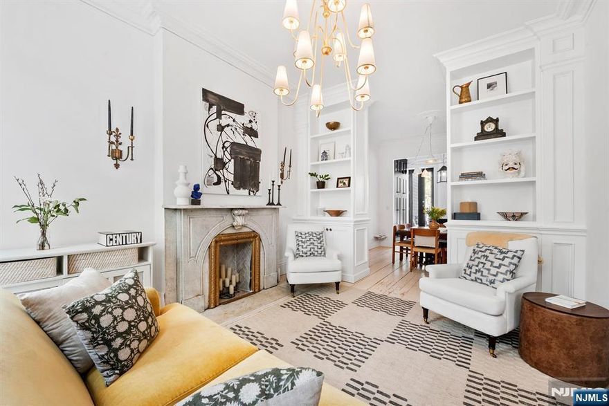 Welcome to 633 Jersey Avenue, a stunning 1885 brownstone in Downtown Jersey Cityâ€™s coveted Hamilton Park. Thoughtfully reimagined by Rose + Co Interiors, this two-family home blends historic charm with modern luxury, featuring a 4-bed, 3.5-bath ownersâ€™ triplex above a beautifully finished 1-bed garden rental. A full 2021 renovation updated all major systems while preserving its original character. The ownersâ€™ triplex showcases restored wide-plank pine floors, intricate plasterwork, crown moldings, and an original marble fireplace. The living room offers soundproof Marvin windows, while a refined library features a salvaged Plaza Hotel mantle and a hidden mechanical room behind a custom bookshelf. The chefâ€™s kitchen impresses with custom cabinetry, Arabescato marble countertops and backsplash, and matte black GE Café appliances with a 6-burner range. The primary suite is a spa-like retreat with marble finishes, dual vanity, and premium Waterworks fixtures. Additional highlights include custom built-ins, a stylish laundry room, and a charming kidsâ€™ bath with a clawfoot tub. Upgrades include new plumbing, electrical, sewer line, 3-zone HVAC, water filtration system, and a Navien tankless heater. The exterior has been fully restored, with a rebuilt stoop and durable PVC roof (2018). Enjoy a private Trex deck and a rare, secluded backyard. Just moments from PATH and Hamilton Park, this Design NJâ€“featured home is a true blend of history and modern living.