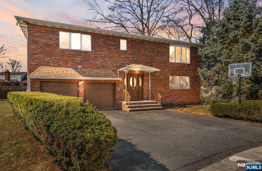 This exceptional Fair Lawn residence in a highly sought-after neighborhood offers a perfect blend of modern comfort and functionality across its beautifully finished living spaces. The first floor features an open-concept layout with sun-filled living areas, highlighted by a cozy wood-burning fireplace and a spacious kitchen with ample cabinetry, complemented by two generous bedrooms, a full bathroom, and a convenient laundry room, plus an oversized 2-car garage with abundant storage. The second floor presents three additional bedrooms including a primary suite with a private en-suite bathroom, a large living room, and a second kitchenâ€”creating an ideal setup for extended living or guest space. Gleaming hardwood floors flow throughout the homeâ€™s warm living spaces. Situated in a prime location within the top-rated Fair Lawn school district, the property is walkable to parks, with easy access to local shopping/dining and major highways (Route 208/Garden State Parkway) offering multiple NYC commuting options.