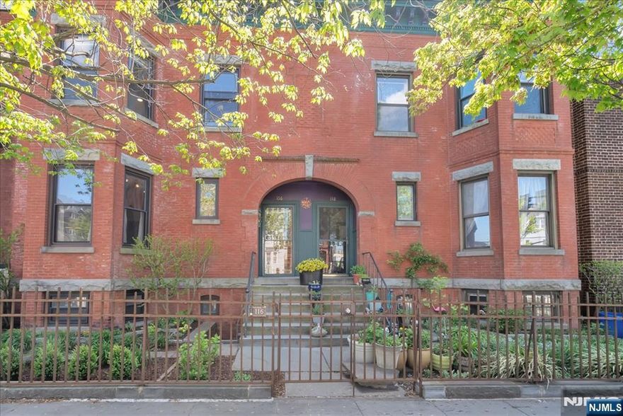 Charming Victorian row house offering 4 bedrooms and 1.5 bathrooms, blending classic character with modern comfort in Newark's Forest Hill neighborhood. Step inside through a welcoming foyer that opens to an elegant main floor filled with abundant natural light. The living room is anchored by a fireplace with an electric insert, while the dining room features a second decorative fireplace, a classic Victorian touch. The kitchen is appointed with stainless steel appliances and a breakfast bar, ideal for casual dining. A powder room finished with a stained-glass window adds charm, while original architectural details throughout the main level highlight the home's timeless appeal. Head upstairs beneath a skylight that floods the stairwell with daylight, where you'll find all four bedrooms and a full bathroom crowned by a second skylight. The primary bedroom features a walk-in closet, a rare amenity in a home of this era, with generous storage throughout. Year-round comfort is provided by a combination of radiator heat and mini-split systems for both heating and cooling. The private backyard offers a patio and dedicated barbecue area, perfect for outdoor entertaining or quiet relaxation. Ideally located near Branch Brook Park with views of the iconic Cathedral Basilica of the Sacred Heart, this home also offers excellent commuter convenience, with a nearby light rail station providing easy access to Downtown Newark in under 10 minutes and onward connections to Hoboken and NYC.